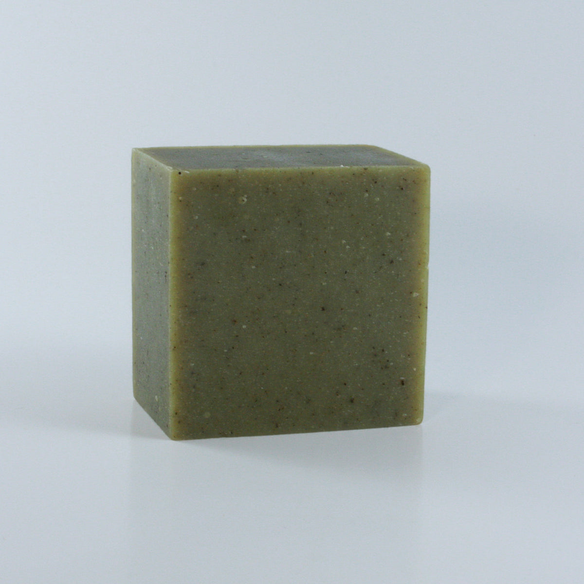 Garden Grove Rosemary Mint Soap with a olive green speckled texture and clean rectangular shape photographed from an angle.