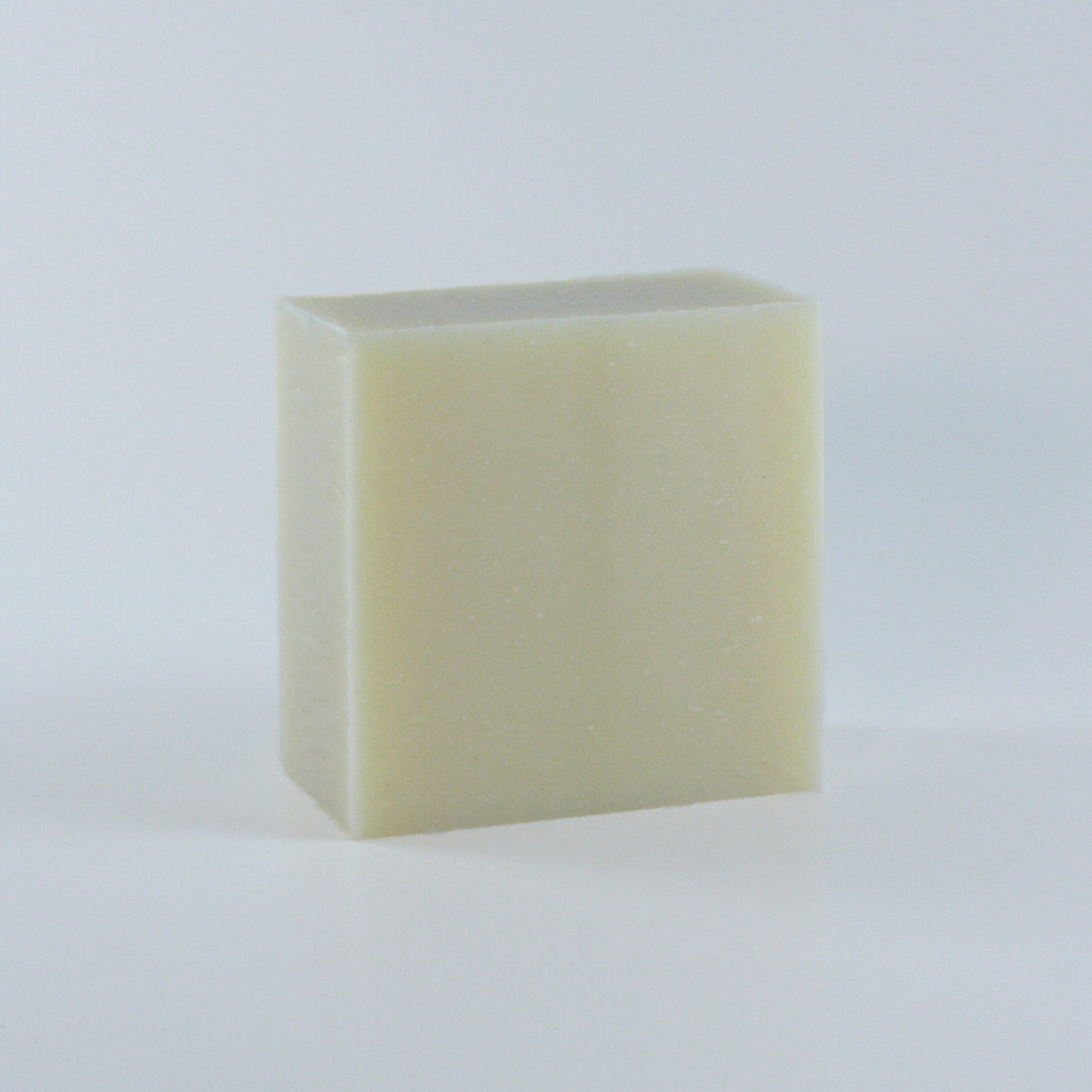 Simple Life Unscented All-Purpose Soap with a creamy texture and off-white finish and clean rectangular shape photographed from an angle on a neutral background.