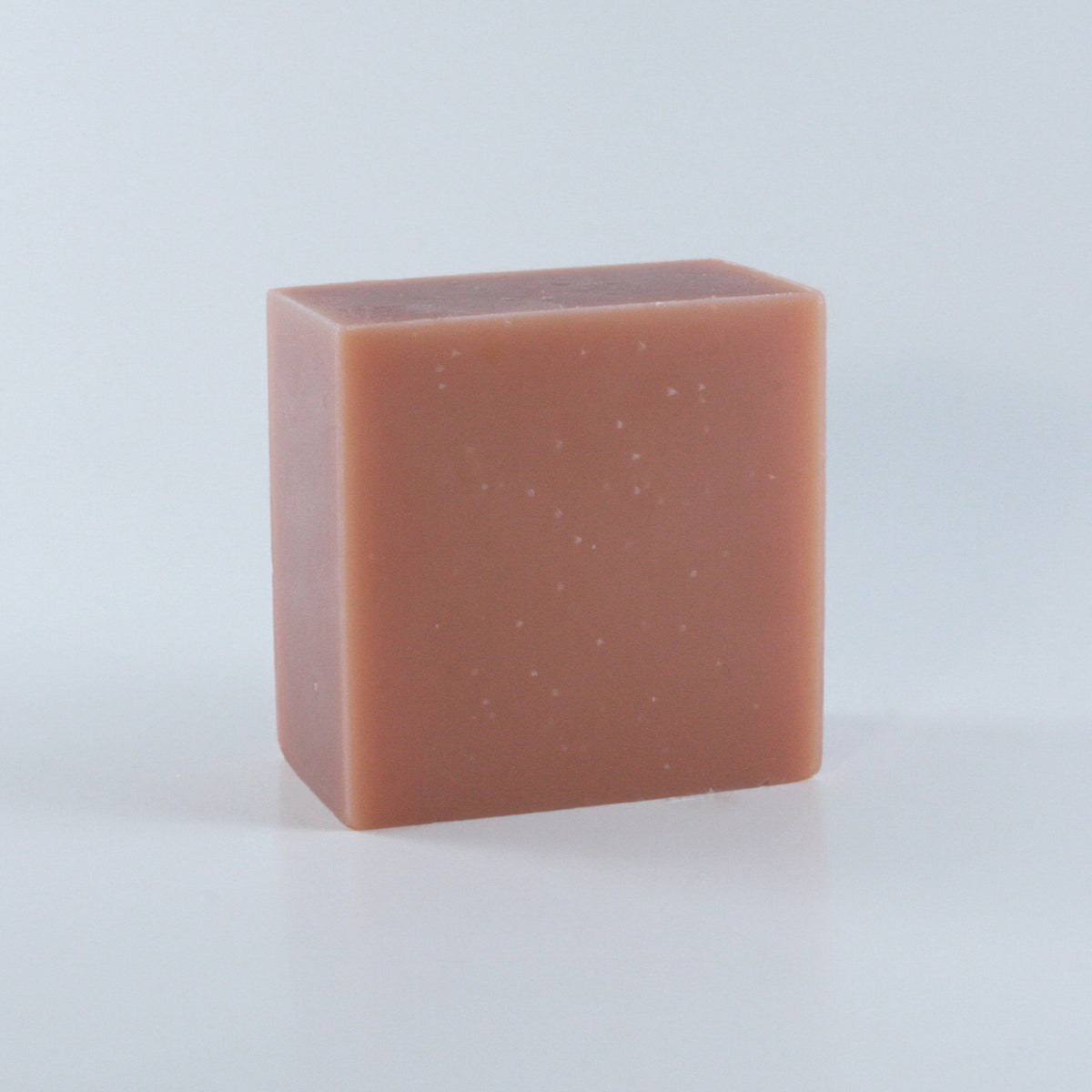Hippie Hollow Patchouli Soap with a blush pink finish and clean rectangular shape photographed from an angle on a neutral background.
